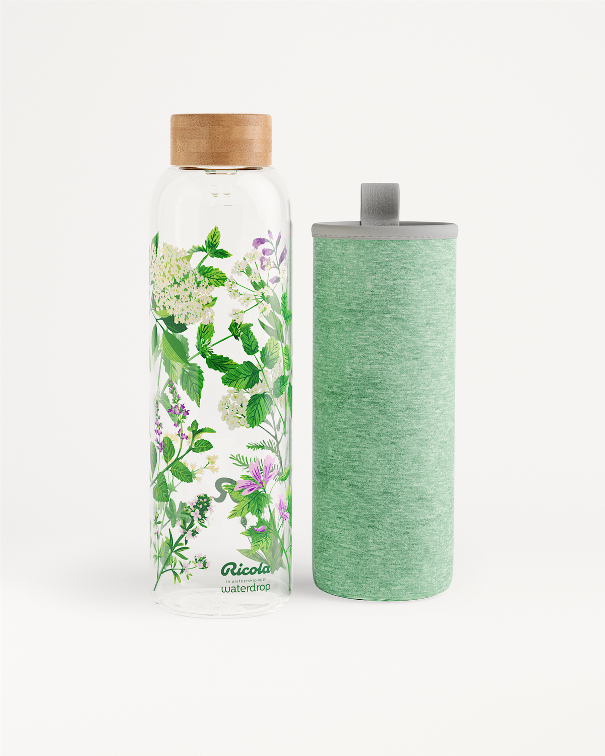 Ricola Edition Glass bottle with floral motif and sleeve.